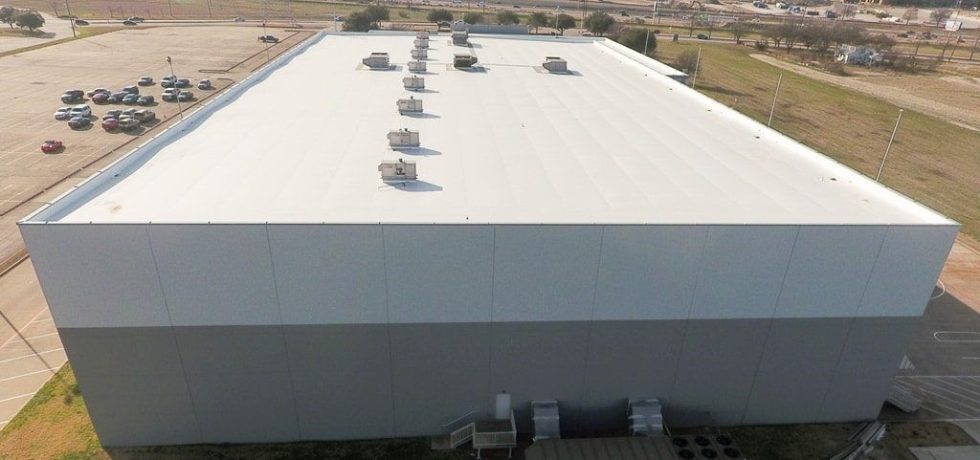 White TPO membrane roof on large commercial warehouse